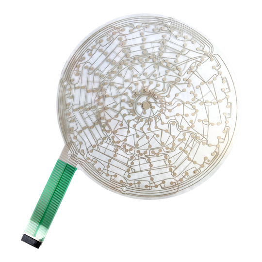 Karella E-Master spare part Auf dem Bild ist eine runde, transparente Leiterplatte mit feinen Leiterbahnen zu sehen. An der linken Seite befindet sich ein grünes Flachbandkabel zum Anschluss.