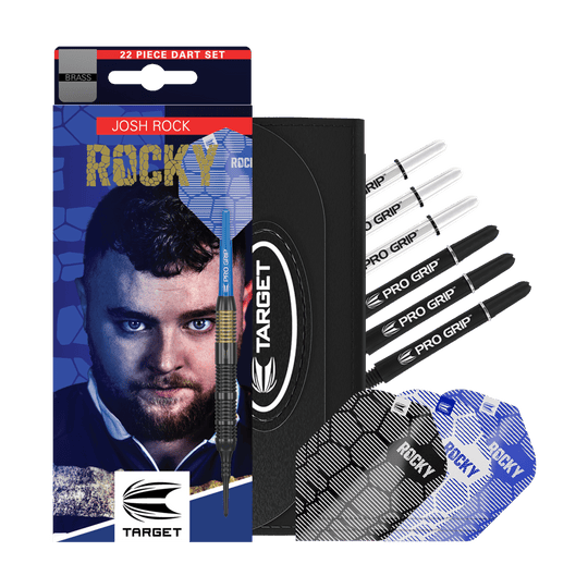 Target Josh Rock Brass Soft Darts - 18g Das Bild zeigt das Produkt "Target Josh Rock Brass Softdarts - 18g" mit Zubehör wie Flights und Shafts. Auf der Verpackung ist ein Porträt sowie der Name des Spielers Josh Rock zu sehen.